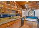 Kitchen with wood cabinets, granite countertops, and blue tile backsplash at 360 Rest Haven Rd, Geneva, FL 32732