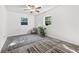 Bright bedroom with wood-look floors, ceiling fan, and ample natural light at 816 Pershing Ave, Orlando, FL 32806