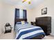 Blue and white striped bedding bedroom with a dresser at 8267 Procida Isle Ln, Windermere, FL 34786