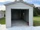 Detached garage with concrete floor and overhead door at 9650 Nw Gainesville Rd, Ocala, FL 34475