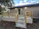 New back patio with wooden railings and tiled flooring at 1009 Herndon St, Leesburg, FL 34748