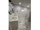 Modern bathroom with double vanity and marble tile at 1009 Herndon St, Leesburg, FL 34748