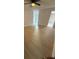 Spacious bedroom with wood-look floors and ceiling fan at 1009 Herndon St, Leesburg, FL 34748