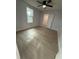Bedroom with wood-look floors and ceiling fan at 1009 Herndon St, Leesburg, FL 34748
