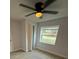 Bright bedroom featuring a window and ceiling fan at 1009 Herndon St, Leesburg, FL 34748