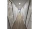 Bright hallway with light grey walls and wood-look flooring at 1009 Herndon St, Leesburg, FL 34748