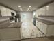 Modern kitchen with white cabinets, granite counters, and stainless steel appliances at 1009 Herndon St, Leesburg, FL 34748