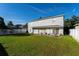 Large backyard with grassy lawn, patio, and white vinyl fence at 1349 Castleport Rd, Winter Garden, FL 34787