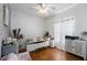 Home office with white desk, geometric wall accents, and hardwood floors at 1349 Castleport Rd, Winter Garden, FL 34787
