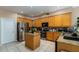 Spacious kitchen with light wood cabinets, granite countertops, and stainless steel appliances at 1349 Castleport Rd, Winter Garden, FL 34787