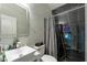 Modern bathroom with a sleek vanity, walk-in shower, and dark tile at 1349 Castleport Rd, Winter Garden, FL 34787