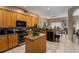 Open concept kitchen with island, ample cabinetry, and granite countertops at 1349 Castleport Rd, Winter Garden, FL 34787