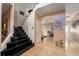 Elegant entryway with black marble staircase and view into living area at 1349 Castleport Rd, Winter Garden, FL 34787