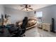 Cozy bedroom featuring a bed, desk setup, and ample natural light at 1349 Castleport Rd, Winter Garden, FL 34787