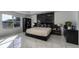 Spacious bedroom with large window, tiled floor, and a black headboard at 1349 Castleport Rd, Winter Garden, FL 34787