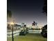 Night view of community clubhouse and golf cart parking at 2025 St George Dr, Davenport, FL 33837