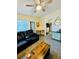 Relaxing living room featuring a leather sofa and a view of the kitchen at 2025 St George Dr, Davenport, FL 33837