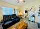 Relaxing living room featuring a leather sofa and a view of the kitchen at 2025 St George Dr, Davenport, FL 33837