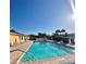 Community pool with surrounding lounge chairs and patio area at 2025 St George Dr, Davenport, FL 33837