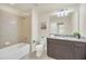 Bathroom features a granite countertop vanity, shower/tub combo, and tile flooring at 2468 Dubai St, Kissimmee, FL 34747