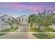 Two-story house with gray siding, landscaping, and a paved driveway at 2468 Dubai St, Kissimmee, FL 34747
