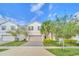 Two-story home with gray garage door and landscaping at 2468 Dubai St, Kissimmee, FL 34747