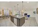 Open concept kitchen with large island and breakfast bar, overlooking living room at 2468 Dubai St, Kissimmee, FL 34747