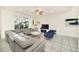 Spacious living room featuring a gray sectional sofa and access to backyard at 2468 Dubai St, Kissimmee, FL 34747
