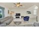 Living area with gray sectional sofa, blue accent chair, and a marble-top coffee table at 2468 Dubai St, Kissimmee, FL 34747