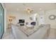 Open living space with gray sectional and views into kitchen and dining area at 2468 Dubai St, Kissimmee, FL 34747