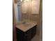 Dark vanity with a white sink and mirror in the bathroom at 2850 N Powers Dr # 9, Orlando, FL 32818