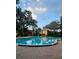 Inviting community pool surrounded by lush landscaping at 2850 N Powers Dr # 9, Orlando, FL 32818