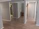 Bright hallway with mirrored closet doors and wood-look flooring at 2850 N Powers Dr # 9, Orlando, FL 32818