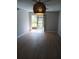 Bright living room with sliding glass doors and stylish light fixture at 2850 N Powers Dr # 9, Orlando, FL 32818