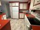 Clean kitchen with red countertops and white appliances at 408 N Niblick Ln, Lake Mary, FL 32746