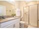 Bathroom with a shower, toilet and sink. White cabinets and gray countertops at 4819 Memories Ln, Kissimmee, FL 34746