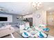 Bright dining area with glass table and chairs, open to kitchen and living room at 4819 Memories Ln, Kissimmee, FL 34746