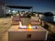 Modern fire pit on a patio with lake view at night at 5007 Tibet Ct, Saint Cloud, FL 34772