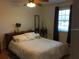 Bright bedroom featuring a comfortable queen-size bed and large window at 616 Georgetown Dr # B, Casselberry, FL 32707
