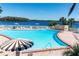 Community pool with lounge chairs and lake view at 616 Georgetown Dr # B, Casselberry, FL 32707
