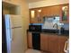 Updated kitchen with wood cabinets, granite counters, and stainless steel appliances at 616 Georgetown Dr # B, Casselberry, FL 32707