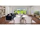Open living room with hardwood floors and views of the patio at 15065 Willow Ridge Dr, Montverde, FL 34756