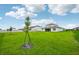 Spacious grassy backyard with a two-story house and a fence at 15065 Willow Ridge Dr, Montverde, FL 34756