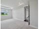 Bright and airy bedroom with neutral carpeting and access to the outside at 15065 Willow Ridge Dr, Montverde, FL 34756
