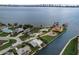 Aerial view of waterfront property with a vacant lot and canal access at 213 Sandy Cir, South Daytona, FL 32119