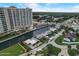 Aerial view showing a canal-front home near a high-rise building and other houses at 213 Sandy Cir, South Daytona, FL 32119