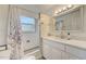 Updated bathroom with a shower and white vanity at 213 Sandy Cir, South Daytona, FL 32119