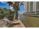 Relaxing dockside view with a lounge chair, overlooking the waterway at 213 Sandy Cir, South Daytona, FL 32119