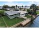 Waterfront home with a green exterior and private dock at 213 Sandy Cir, South Daytona, FL 32119