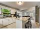 Open concept kitchen with white cabinets, granite countertops and island at 213 Sandy Cir, South Daytona, FL 32119